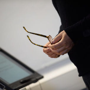 Person holding glasses.