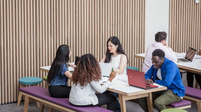 Four students sat at a table on UWE Bristol campus