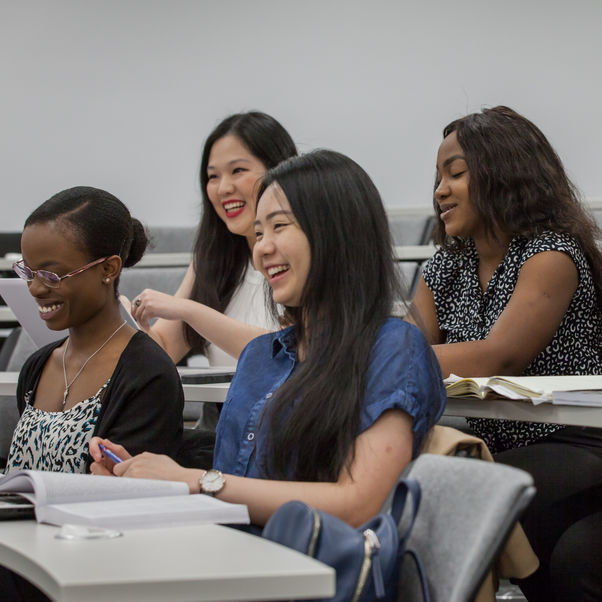 A group of smiling students in a lecture hall