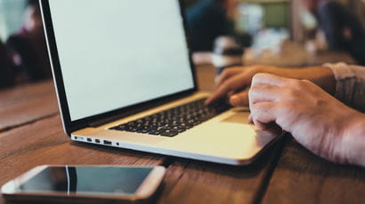 Close up shot of hands using a laptop