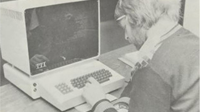 Archie photo of a person using a computer.