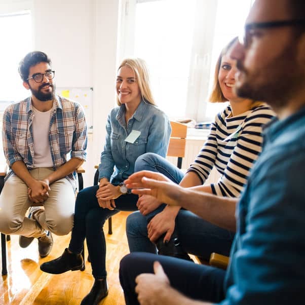 People sat in a room in a therapy setting.