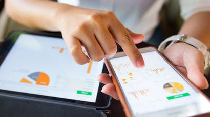 A tablet and a mobile phone showing data displayed on graphs