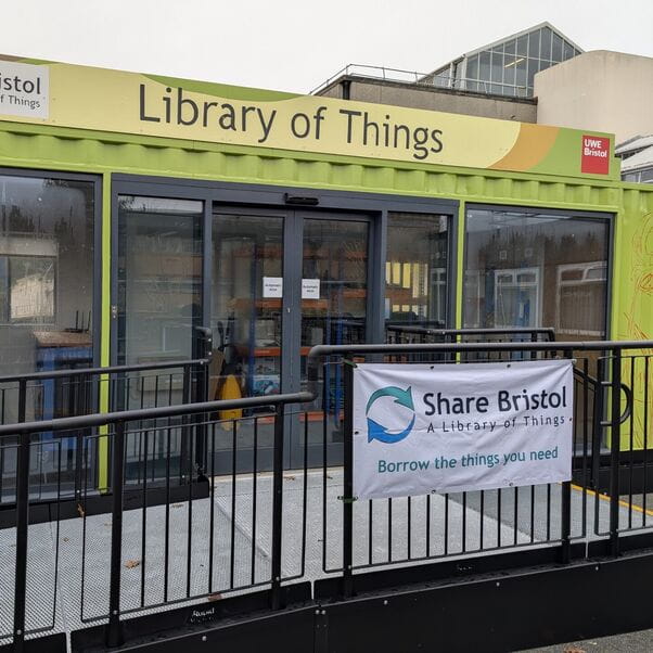 The Library of Things, a green shipping container with French doors and a ramp up to them.