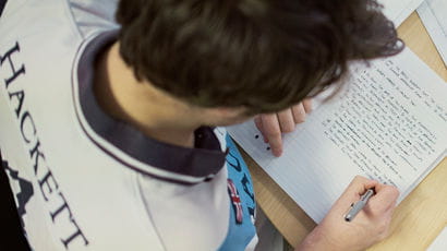 Aerial shot of a student writing in their notebook