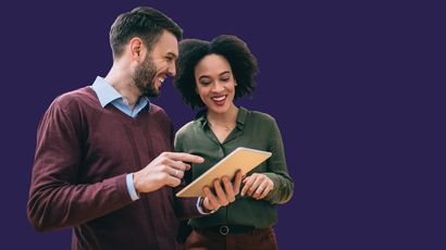 Two people looking at a clipboard.