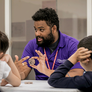 BoxED staff member working with two pupils.