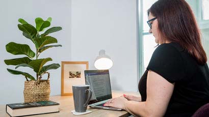 Woman sat at a desk on a laptop