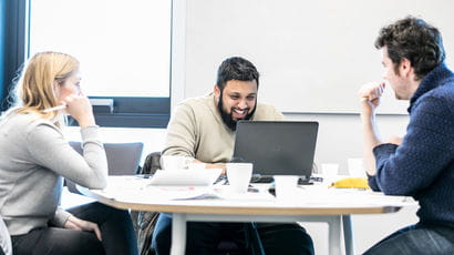 Student and colleagues working on a project