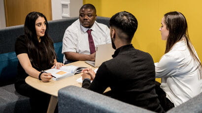 Four people collaborating around a desk