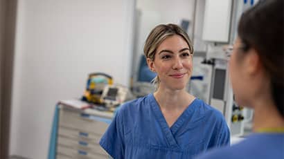 NHS workers chatting on a hospital ward.