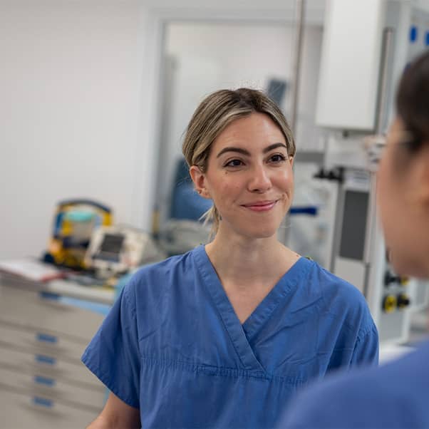 NHS workers chatting on a hospital ward.