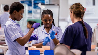 Nursing students being trained by a lecturer.