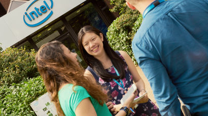 Group of international placement students standing and having a discussion.