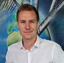 Portrait image of Rob Ogden - Help to Grow Management course participant - against colourful background.