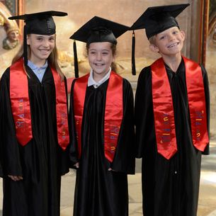 Children's University graduates wearing robes.