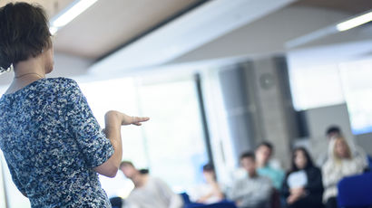 Person giving a presentation in a teaching room.