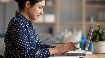 Person working on a laptop at home.