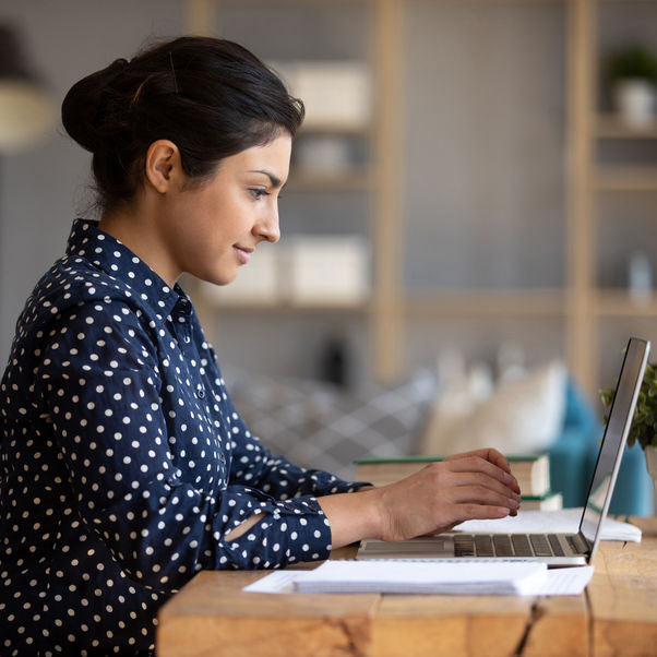 Young person working at a table at home.