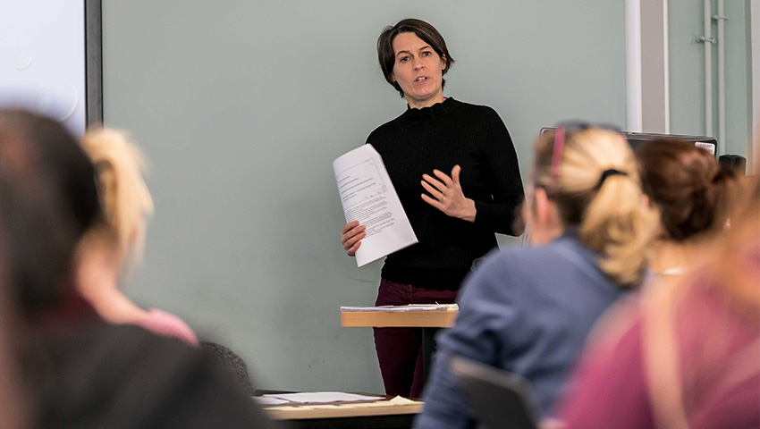 Lecturer delivering a talk to a group of healthcare students.