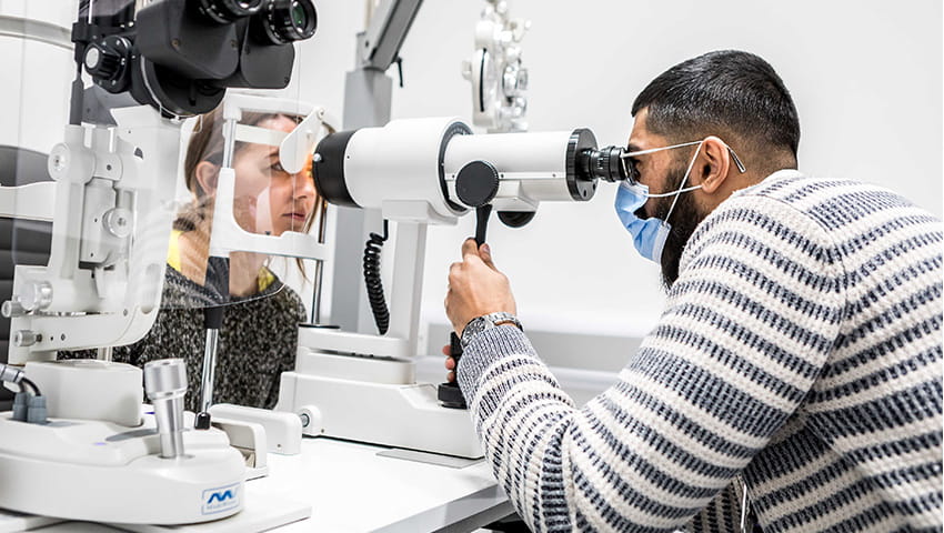 Student optometrist testing a patient's eye sight at the UWE Bristol Eye Clinic.