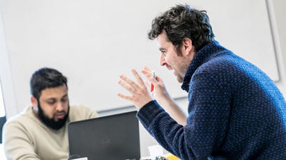 Member of staff talking to a student.