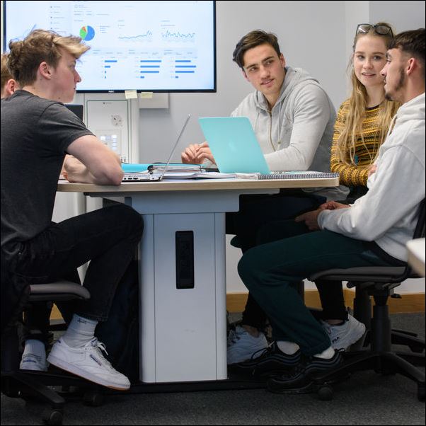 Students working on a project in a study room.