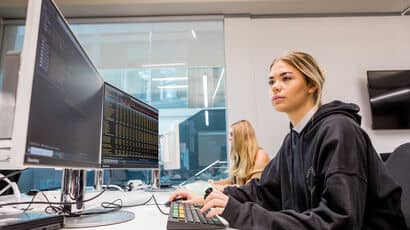 Two female accounting students each working at a computer.