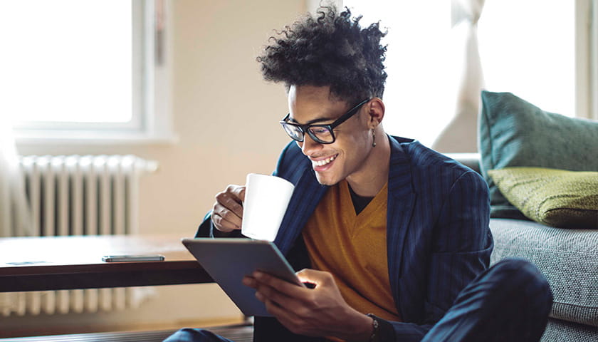 Prospective student using an iPad at home to apply to university.