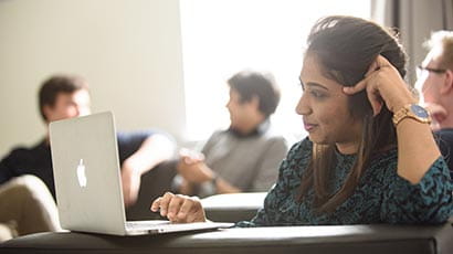 A student doing an application on a laptop