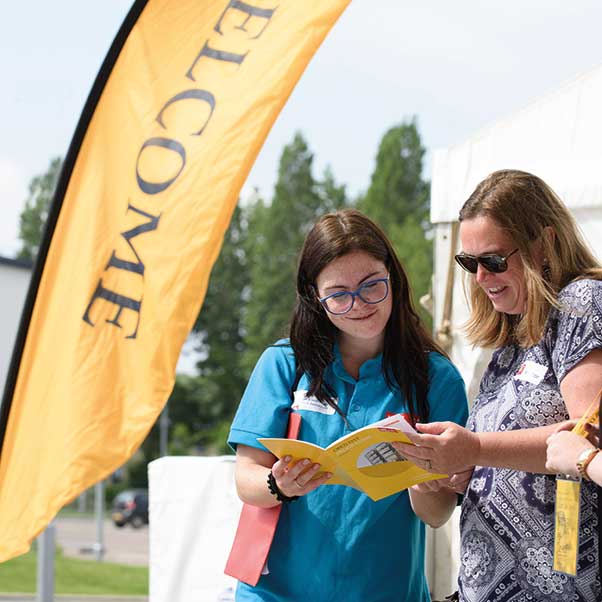A student ambassador helping an Open Day attendee.