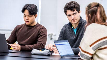 Couple of students in discussion around a table