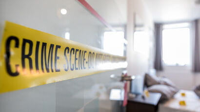 Room with yellow crime scene tape.