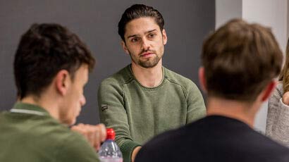 Students in discussion around a table