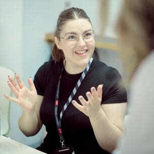 Smiling woman gesticulating whilst talking