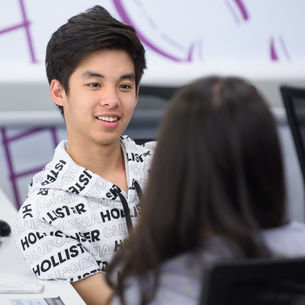 Two students having a discussion in a study space