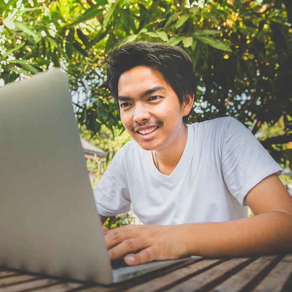 A male checking his results on his laptop