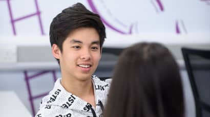 Student engaged in conversation at a desk