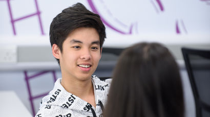 Student engaged in conversation at a desk