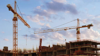 Building construction image showing cranes. 