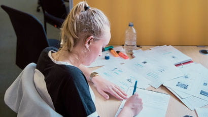 A student writing in the library