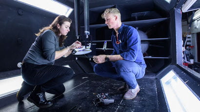 Student doing engineering work in an aircraft.