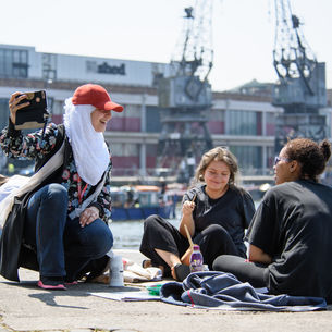 Creative students taking a photo of themselves at Bristol harbourside