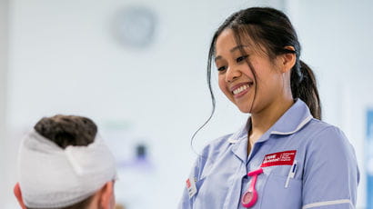 Nursing apprentice smiles at patient