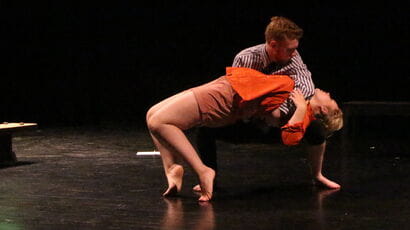 Students performing on a stage