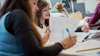 Students studying around a table in a study space.