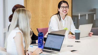 Group of smiling CPD students with laptops