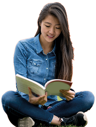 Student sitting cross legged reading a book