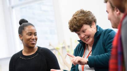 Students sat in a group and smiling.