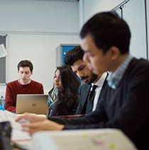 A group of smartly dressed students in a classroom.